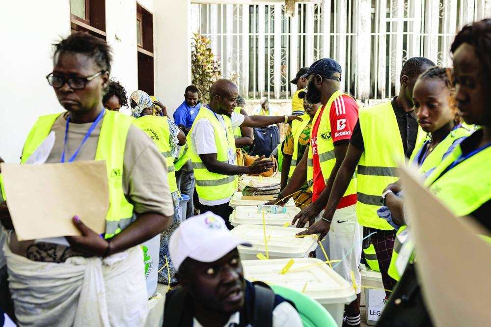 Officials from the National Electoral Commission (CNE) collect documents accompanying ballot boxes received from different polling stations at their headquarters in Bissau, Monday, the day after Guinea-Bissau’s presidential and legislative elections.