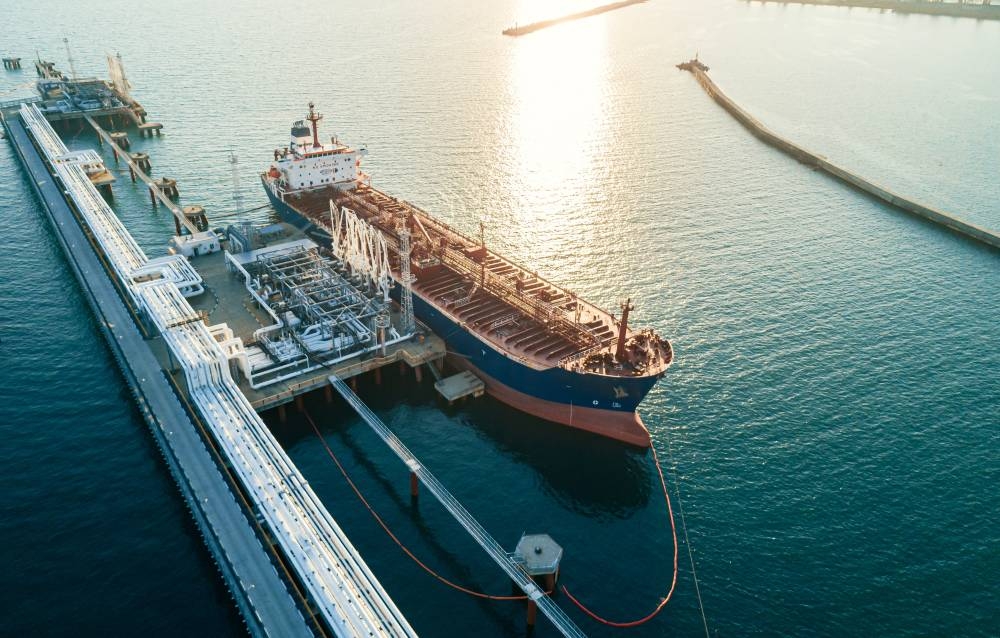 Aerial view of a large oil tanker docked at a pier in the port in process of loading. Crude futures fell marginally on Friday as investors considered oil's geopolitical risk premium amid drawn-out Russia-Ukraine peace talks, while keeping an eye on Sunday's Opec  meeting for clues about potential output changes. 
