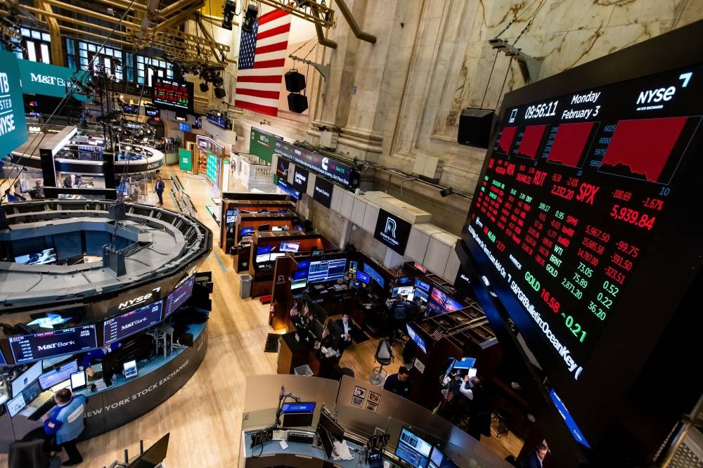 Traders work on the floor of the New York Stock Exchange (NYSE) in New York, US, on Monday, Feb. 3, 2025. US stock index futures declined on Monday after US President Donald Trump announced tariffs on Mexico, Canada and China that threaten to upend global trade.