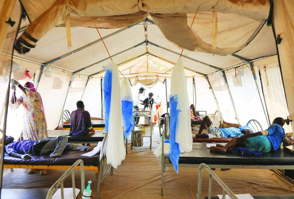 
Injured displaced Sudanese people who fled violence in El-Fasher receive treatment at a makeshift clinic run by Medecins Sans Frontieres (MSF), amid ongoing clashes between the paramilitary Rapid Support Forces (RSF) and the Sudanese army, in Tawila, North Darfur. (AFP) 