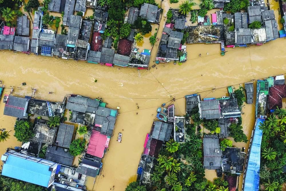 An aerial view shows houses partially submerged in floodwaters after heavy rainfall in Kaduwela on the outskirts of Colombo Saturday.