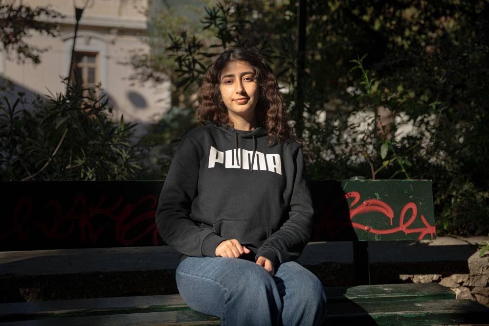 Palestinian refugee Sara al-Sweirki, 20, who now lives in Athens, poses for a portrait.