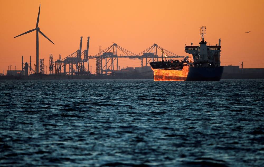An oil tanker is seen at sunset anchored off the Fos-Lavera oil hub near Marseille, France.