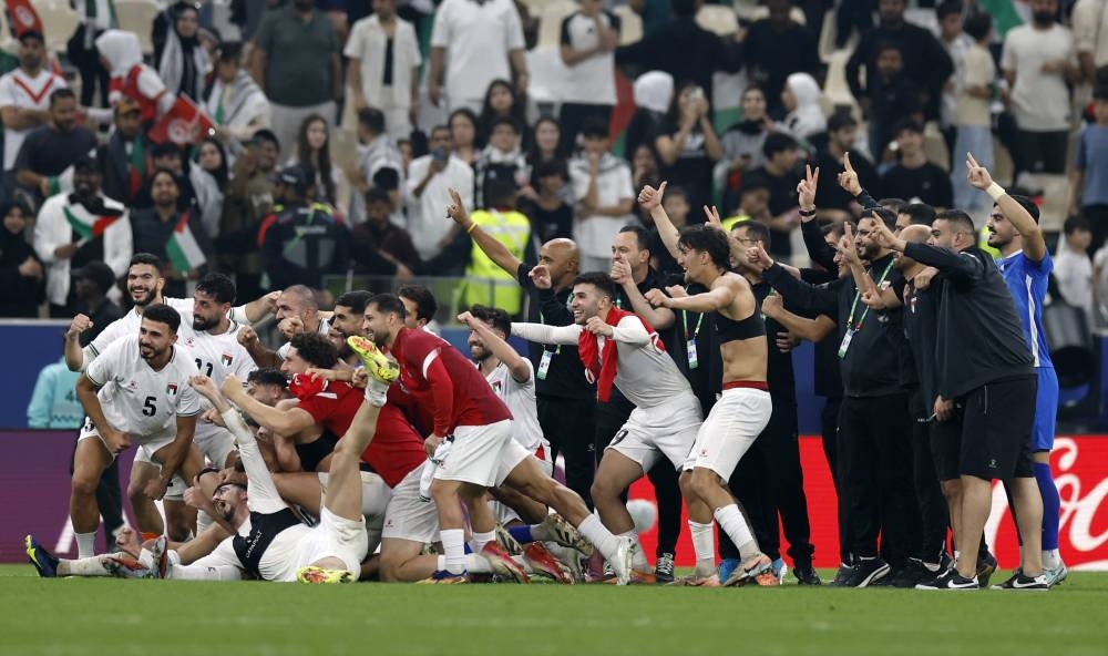 Soccer Football - FIFA Arab Cup - Qatar 2025 - Group A - Palestine v Tunisia - Lusail Stadium, Lusail, Qatar - December 4, 2025
Palestine players and coaches celebrate after the match REUTERS