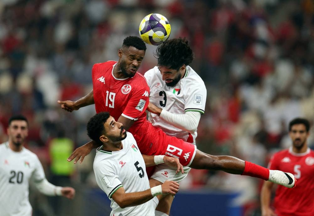 Soccer Football - FIFA Arab Cup - Qatar 2025 - Group A - Palestine v Tunisia - Lusail Stadium, Lusail, Qatar - December 4, 2025
Palestine's Ameed Sawafta and Mohammed Saleh in action with Tunisia's Firas Chaouat REUTERS
