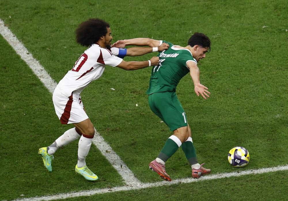 Soccer Football - FIFA Arab Cup - Qatar 2025 - Group A - Syria v Qatar - Khalifa International Stadium, Doha, Qatar - December 4, 2025
Syria's Mohammad Al Salkhadi in action with Qatar's Akram Afif REUTERS