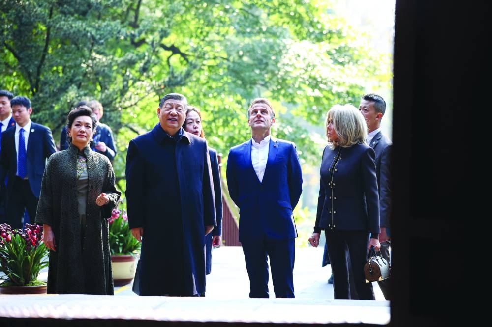 
French President Emmanuel Macron, his wife Brigitte Macron, Chinese President Xi Jinping and his wife Peng Liyuan visit the Dujiangyan site, a designated Unesco World Heritage site, in Dujiangyan, in southwestern China’s Sichuan province yesterday. 