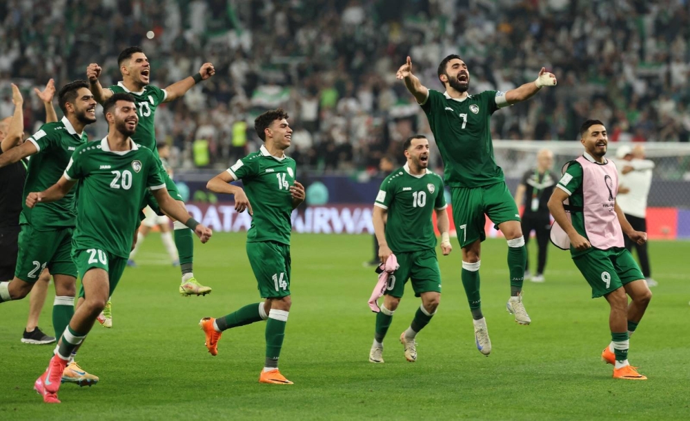 Syria's Omar Maher Khribin celebrates with teammates after qualifying for the knockout stage at the FIFA Arab Cup Qatar 2025 following their Group A match against Palestine at the Education City Stadium on December 7, 2025. The matched ended in a 0-0 draw. (Reuters)