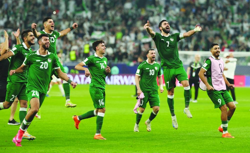 Syria’s Omar Maher Khribin celebrates with teammates after qualifying for the quarter-finals of the FIFA Arab Cup following their match against Palestine Sunday. (Reuters)