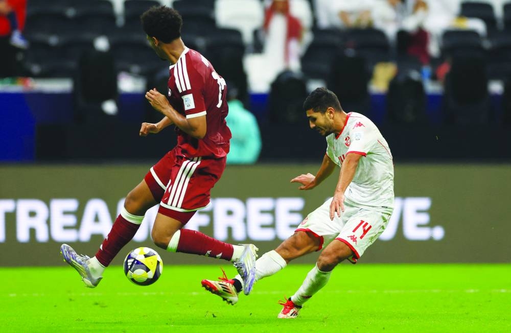 Tunisia’s Mohamed Ben Ali scores their third goal during the FIFA Arab Cup match against Qatar at Al Bayt Stadium in Al Khor Sunday. Tunisia won 3-0. (Reuters)