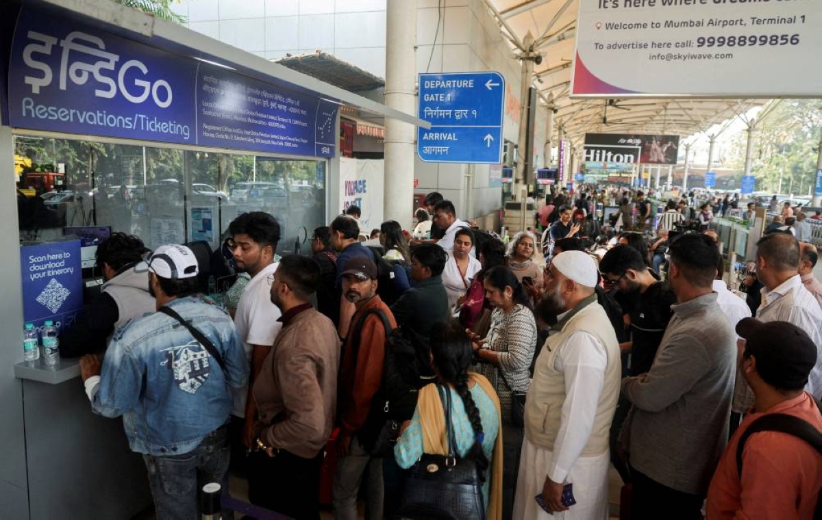 FILE PHOTO: Passengers wait outside the IndiGo airlines ticketing counter at the Chhatrapati Shivaji Maharaj International Airport, after several IndiGo airlines flights were cancelled, in Mumbai, India, December 6, 2025. REUTERS