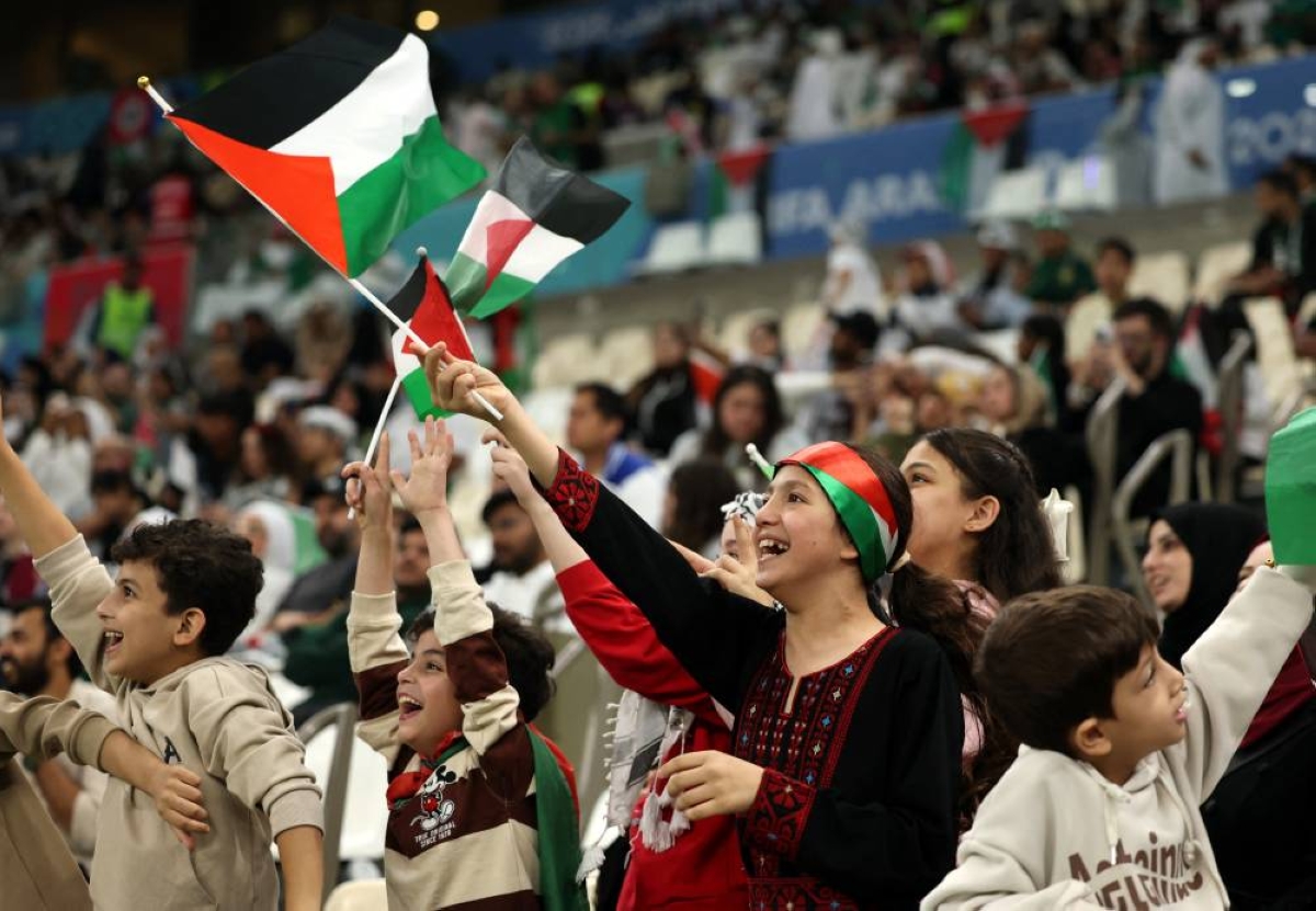 Palestine fans with flags inside the stadium before the match on Thursday. REUTERS