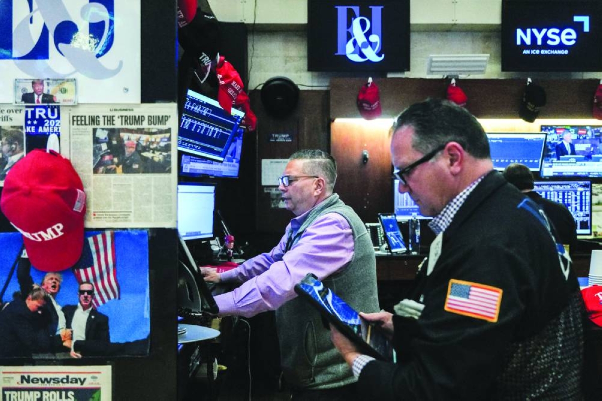 Traders work on the floor at the New York Stock Exchange. A host of delayed employment, inflation and other data in the coming week will give a long-anticipated view of the US economy that could help guide markets into year-end.