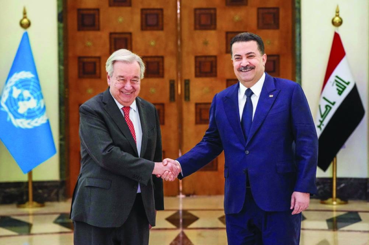 This handout picture released by the office of Iraq's Prime Minister Mohammed S al-Sudani Saturday, shows him (right) shaking hands with United Nations (UN) Secretary-General Antonio Guterres during a meeting in Baghdad.
