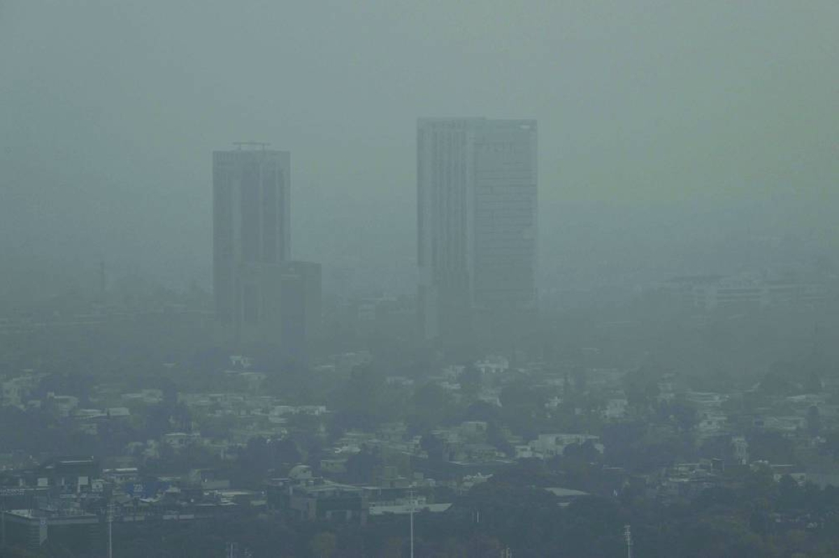 This picture taken last week shows buildings engulfed in dense smog due to severe air pollution in Islamabad. – AFP