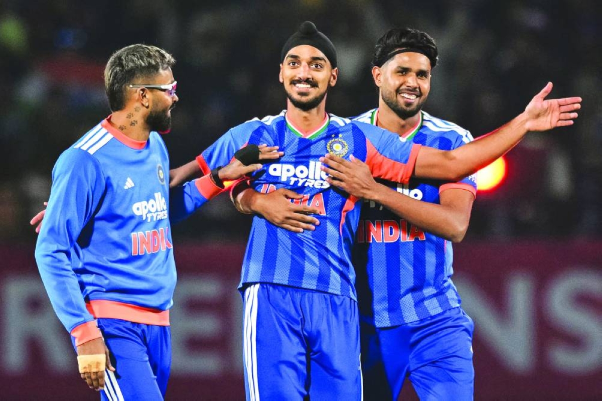 India’s Arshdeep Singh (centre) celebrates with teammates Harshit Rana (right) and Hardik Pandya after taking the wicket of South Africa’s Reeza Hendricks during the third Twenty20 match at the Himachal Pradesh Cricket Association Stadium in Dharamsala Sunday. (AFP)