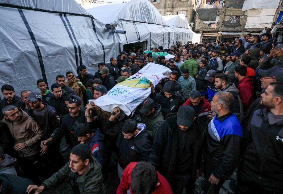 Mourners carry bodies during the funeral of senior commander Raed Saed and his aides, in Gaza City, Sunday.