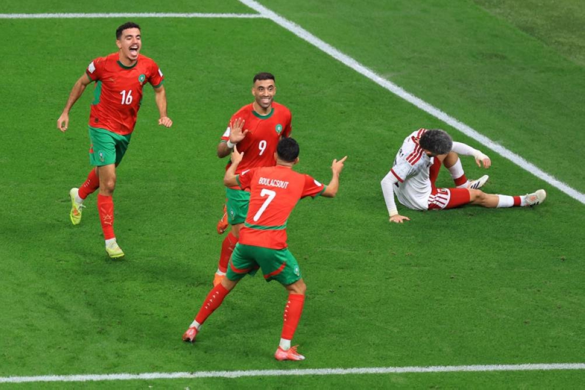 Morocco’s Abderazak Hamdallah celebrates with Mohamed Boulacsout and Aschraf El Mahdioui after scoring against United Arab Emirates at the Khalifa International Stadium in Doha. (Reuters)