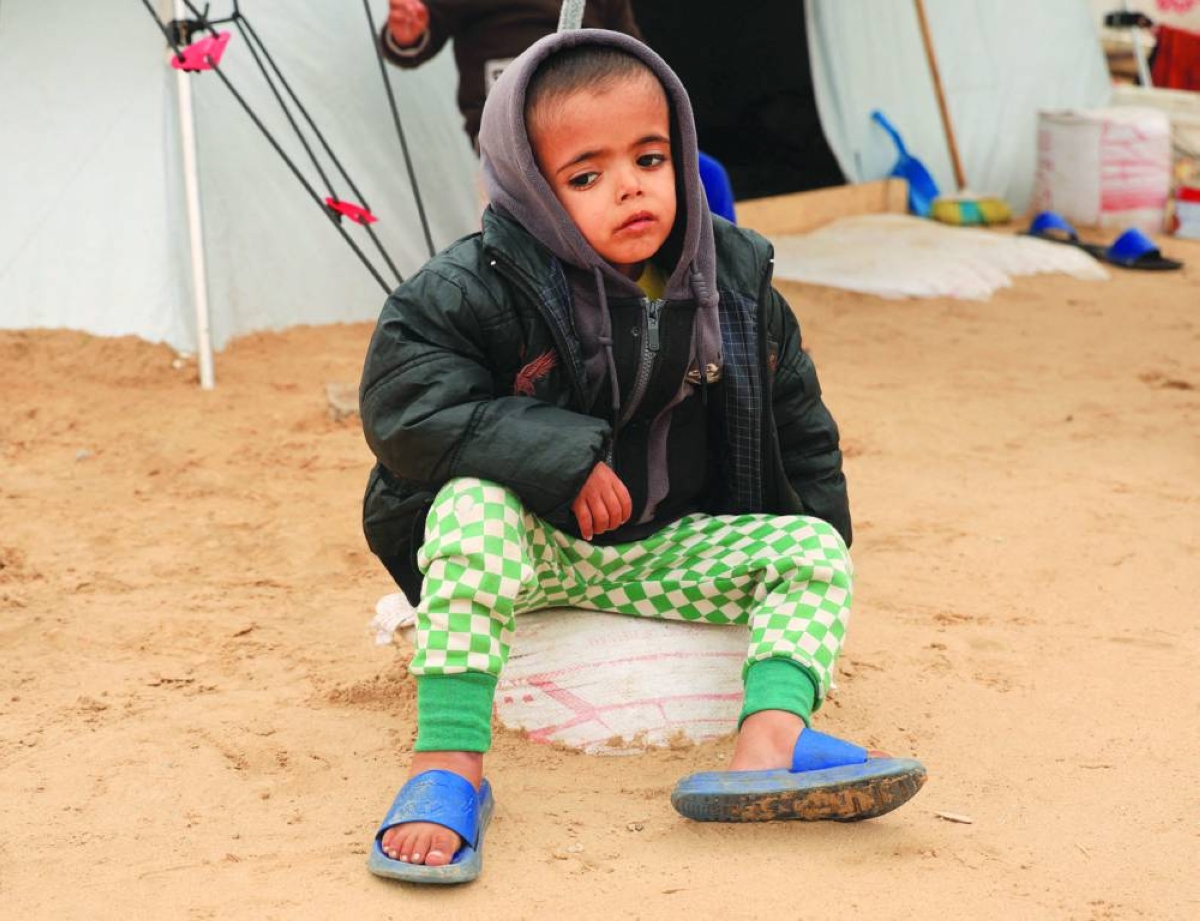 
Displaced Palestinian child Yasser Arafat, 5, who, according to medics, suffers from severe acute malnutrition with nutritional edema, sits in front of his family’s tent at a displacement camp in Khan Younis, southern Gaza Strip. 
