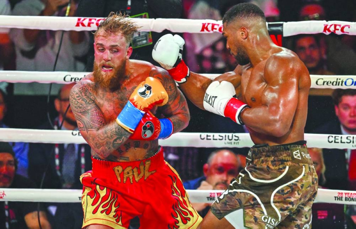 US boxer and influencer Jake Paul (L) and British boxer Anthony Joshua fight in a non-title heavyweight bout at the Kaseya Center in Miami, Florida on December 19, 2025. (AFP)