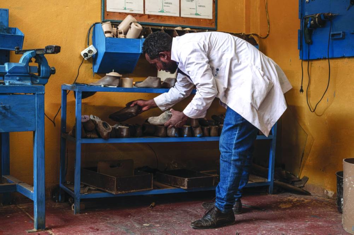 Orthopaedic technician Bashawgize Getie, 33, arranges foot models used for the fabrication of prosthetic limbs inside the technical workshop of the Bahir Dar Physical Rehabilitation Center, supported by the International Committee of the Red Cross (ICRC), in Bahir Dar.