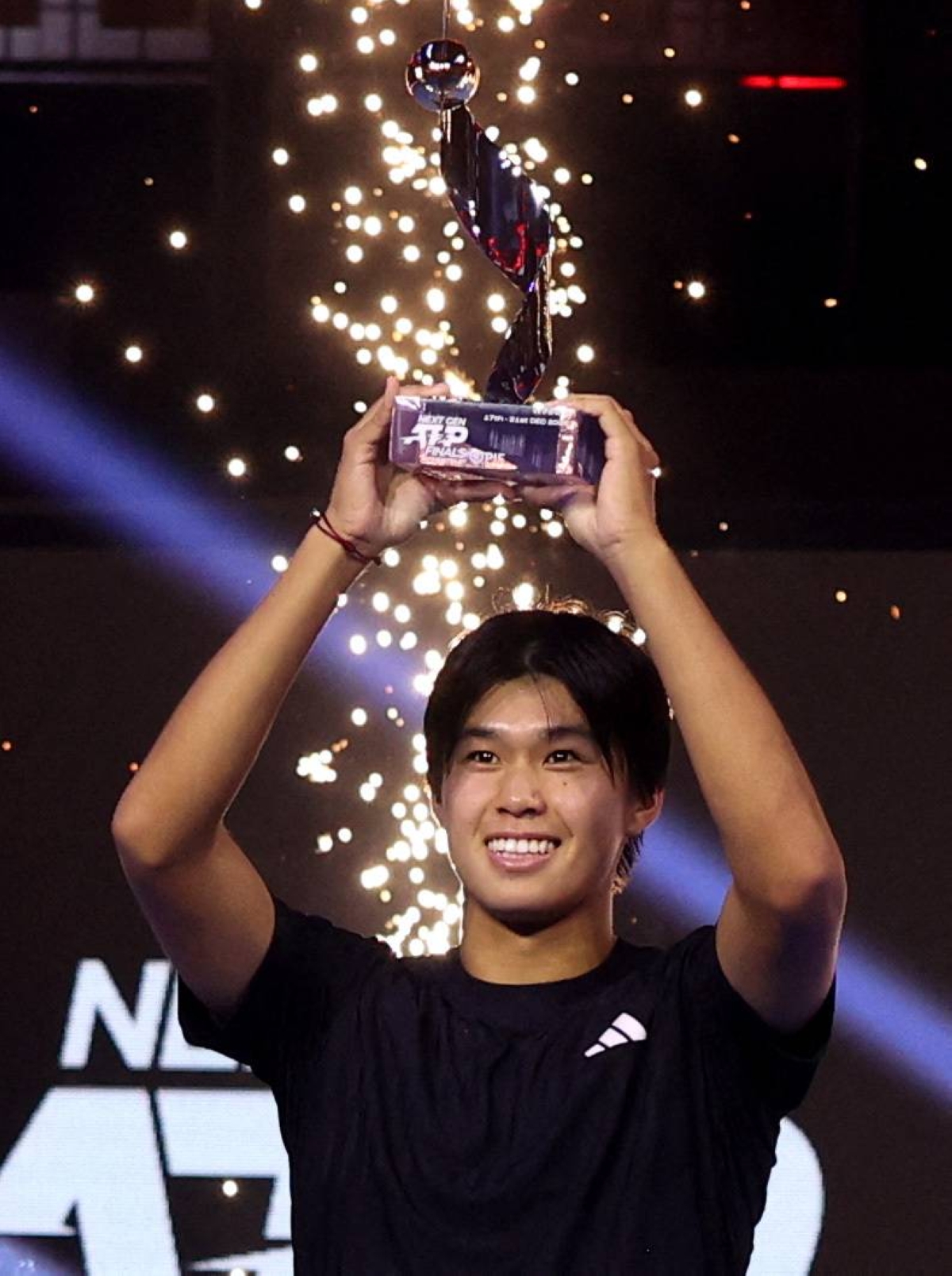 Learner Tien of the US celebrates with the trophy after winning the Next Gen ATP Finals against Belgium's Alexander Blockx in Jeddah. (Reuters)