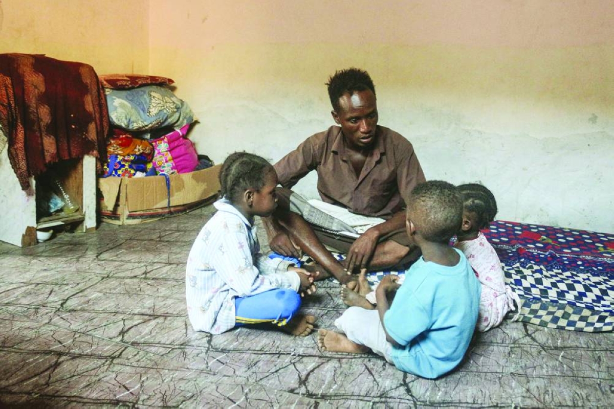 Somali refugee Abdallah Omar sits with his children at a UN Refugee Agency (UNHCR) facility, as they wait for news of their repatriation from Yemen, in Aden on October 23, 2025. In makeshift homes lacking even the most basic necessities surrounded by piles of rubbish and flanked by dirt roads, thousands of Somalis in Yemen live in soul-crushing poverty in Aden's "Little Mogadishu". (AFP)