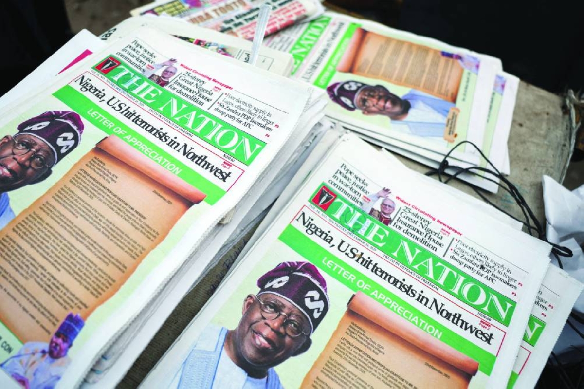 Front pages of newspapers reporting on US airstrikes against Islamic State militants in Nigeria, are displayed at a newspaper stall in Lagos, Nigeria, yesterday.