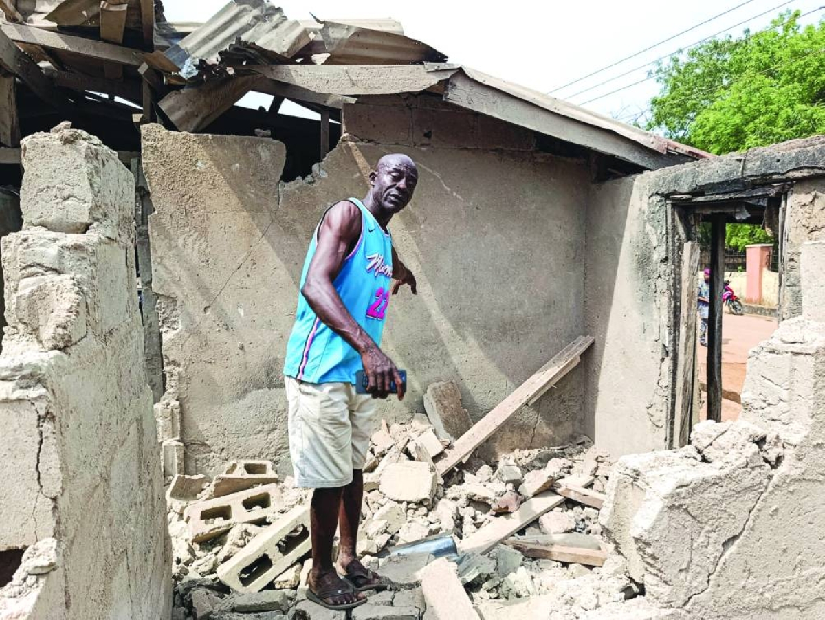 A person stands amid a destroyed building after US forces had launched a strike against Islamic State militants in Nigeria at the request of Nigeria's government, in Offa, Kwara State, Nigeria, yesterday.