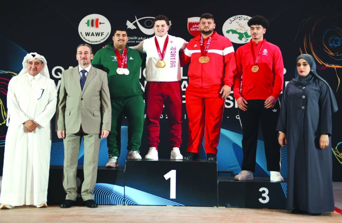
Qatar’s Fares Ahmed Jaber is seen with fellow lifters on the podium. 