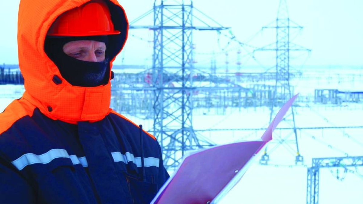 A worker at a substation checking documents. Oil prices settled more than 2% lower on Friday as investors weighed the prospect of a global supply glut, while also monitoring the possibility of a Ukraine peace deal ahead of talks this weekend between the presidents of Ukraine and the United States.