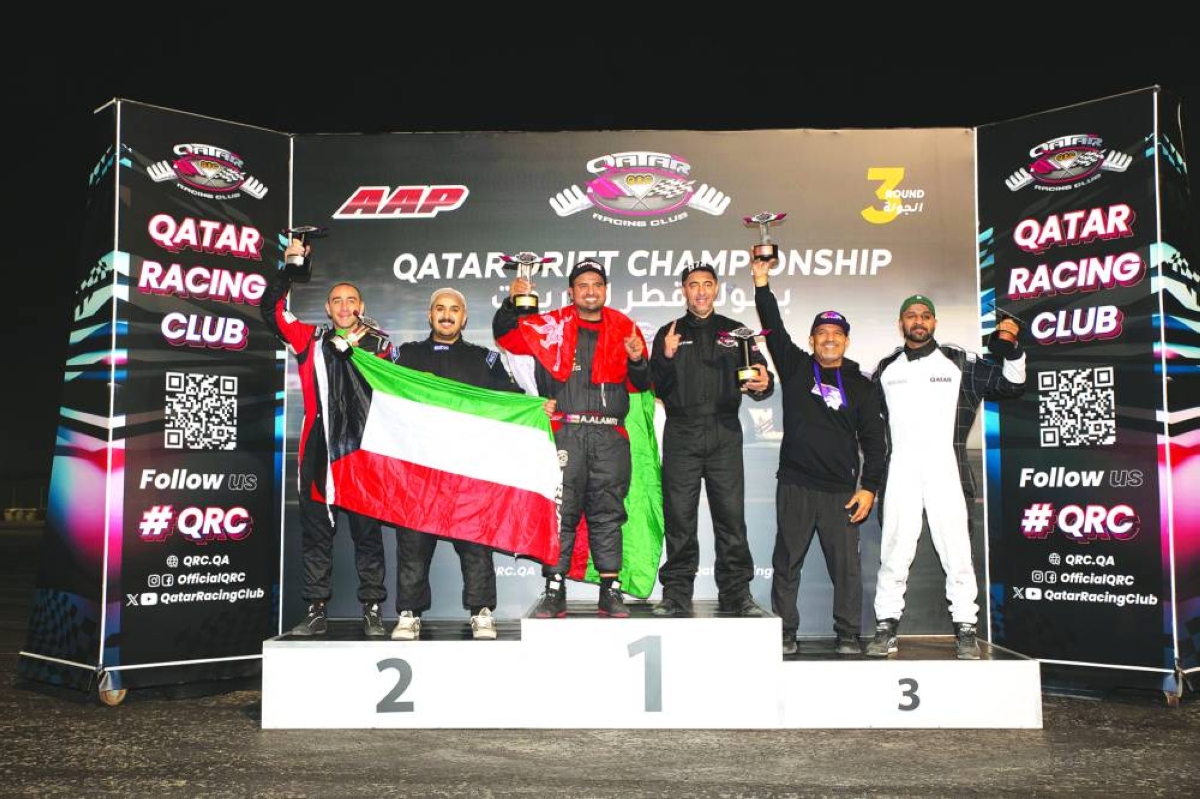 Qatar Drift Championship's third round winners pose on the podium. 