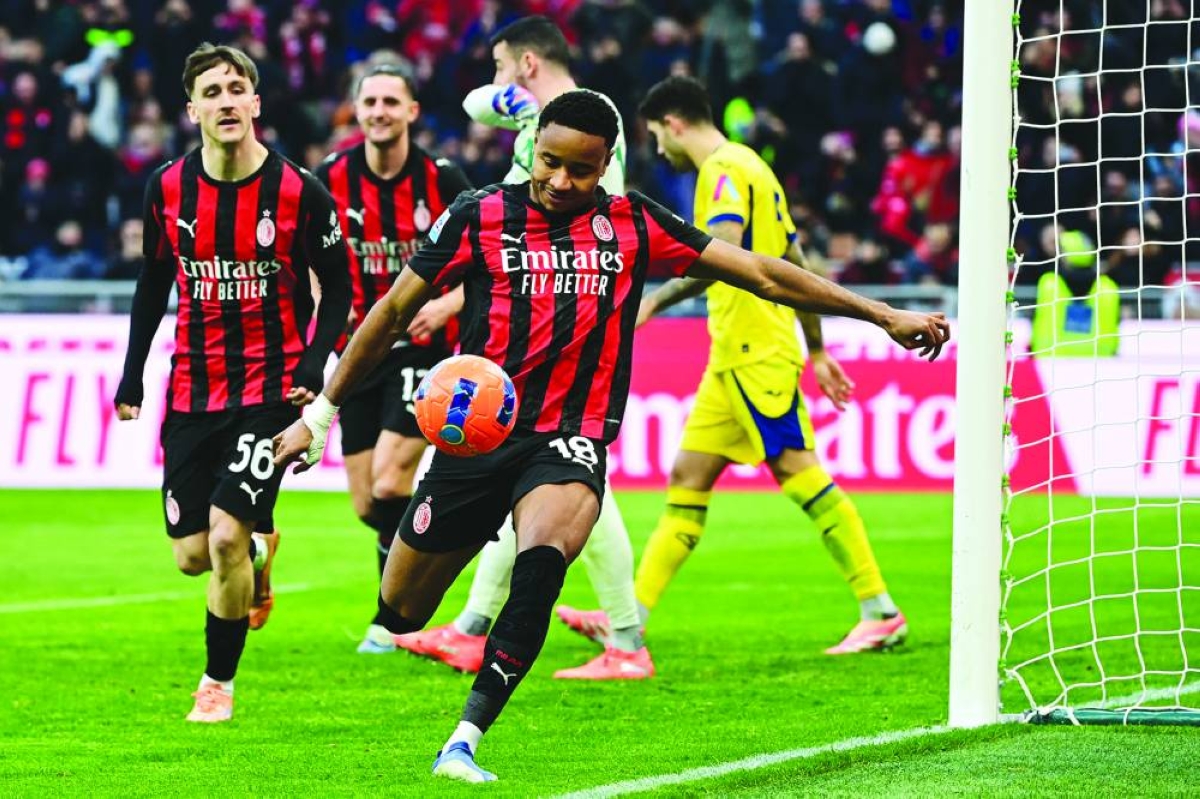 AC Milan's French forward #18 Christopher Nkunku (C) celebrates after scoring his team second goal during the Italian Serie A football match between AC Milan and Hellas Verona at the San Siro stadium in Milan, northern Italy, on December 28, 2025. (Photo by Piero CRUCIATTI / AFP)