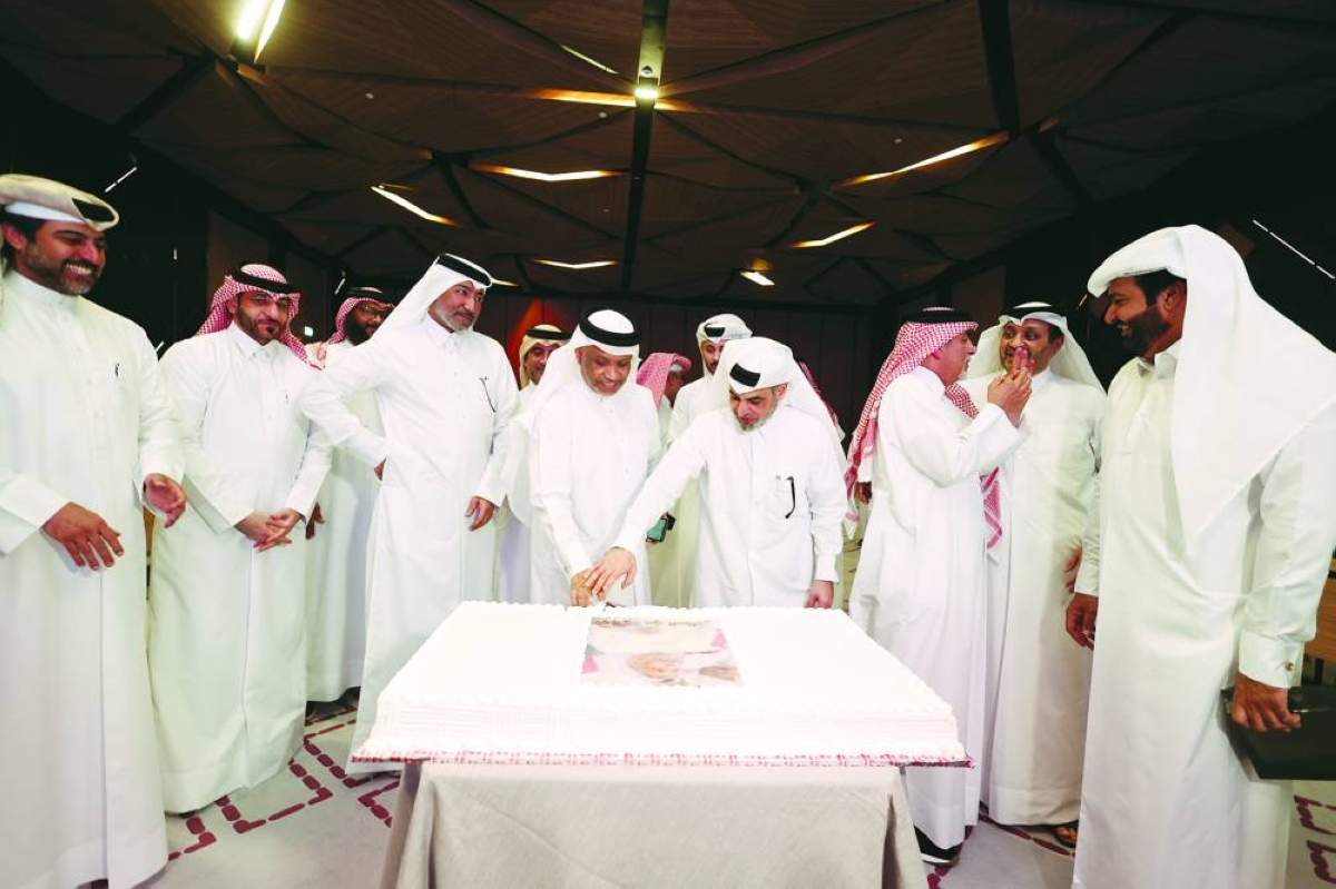 Newly-elected Qatar Table Tennis Association (QTTA) president Hamad Ahmed al-Hammadi cuts a cake with outgoing chief of the federation Khalil al-Mohannadi in Doha on Monday.