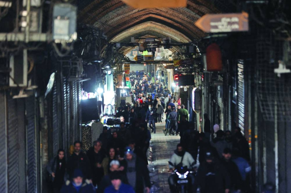 People walk past closed shops, following protests over a plunge in the currency's value, in the Tehran Grand Bazaar in Tehran. – Reuters