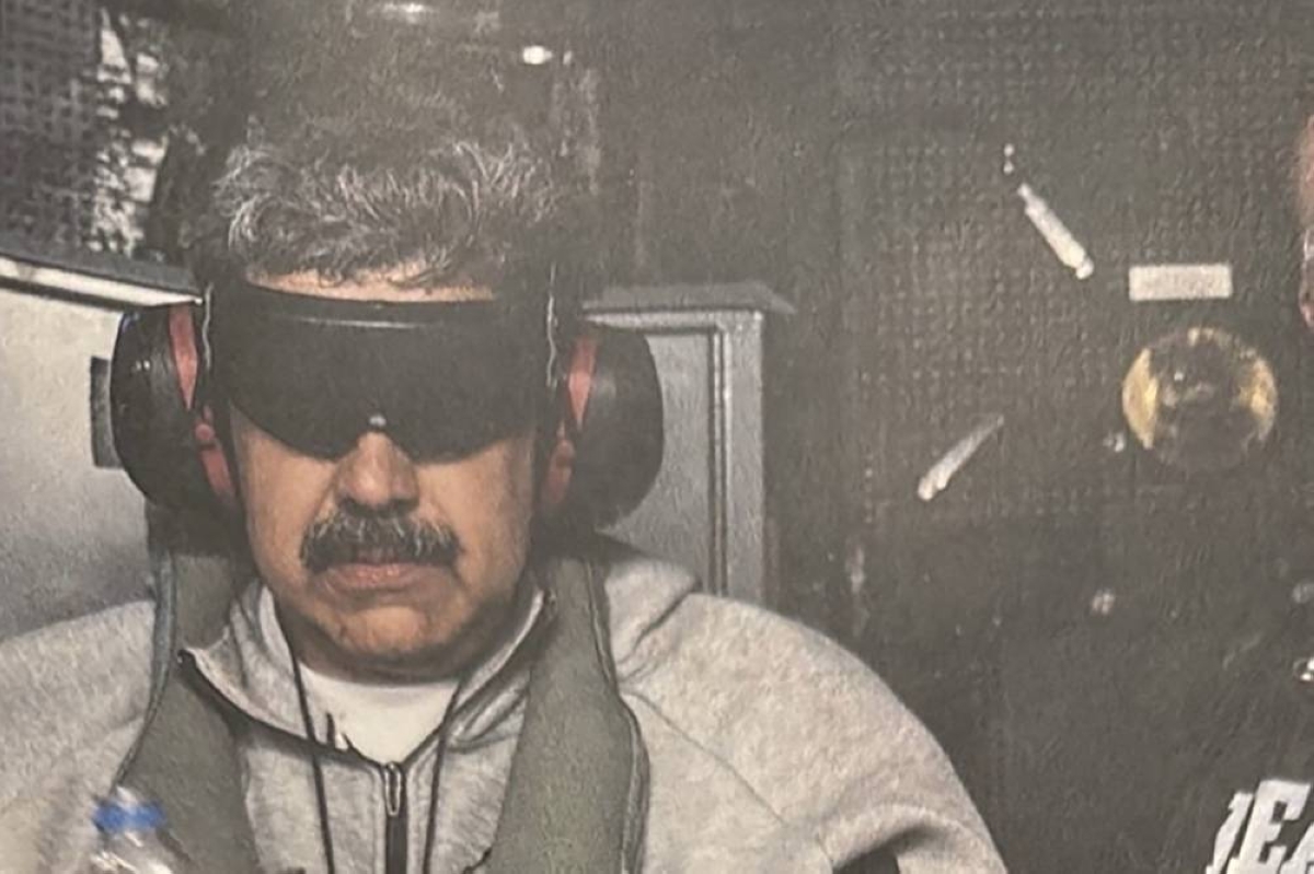 A photograph which U.S. President Donald Trump posted on his Truth Social account shows what he describes as Venezuelan President "Nicolas Maduro on board the USS Iwo Jima" amphibious assault ship, currently in the Caribbean Sea January 3, 2026. The image appears to be taken from a printed photograph, as white edging can be seen around the image. What appears to be the letters DEA can be seen on a black uniformed person next to Venezuelan president Maduro. U.S. president Trump said DEA officials were involved in the operation. Verifying the location was not immediately possible as the photograph is tightly cropped. But the patterning of grey hairs within Maduro's mustache matched recent imagery of him.REUTERS 
