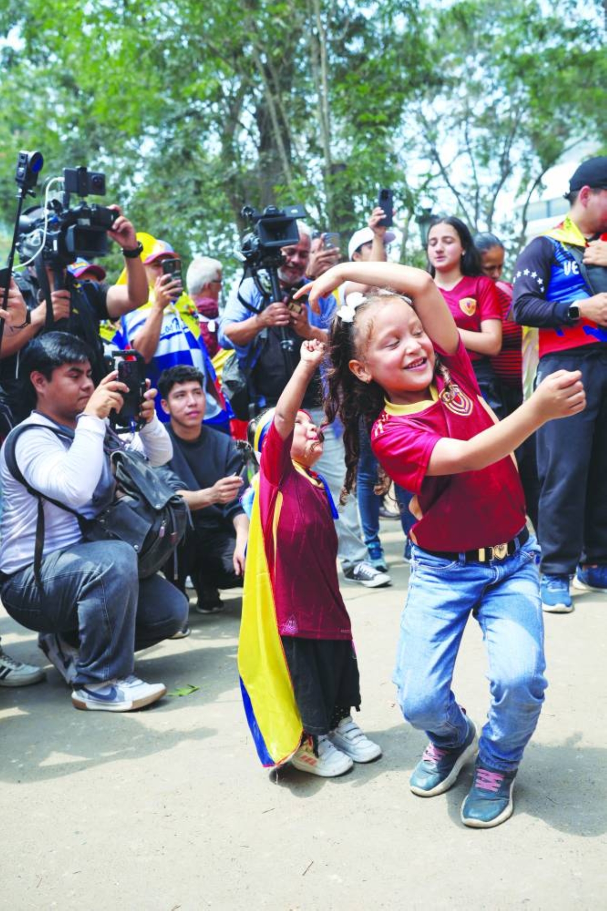 Children dance outside Venezuela's embassy in Lima after the US attacked Venezuela and deposed its president. – Reuters