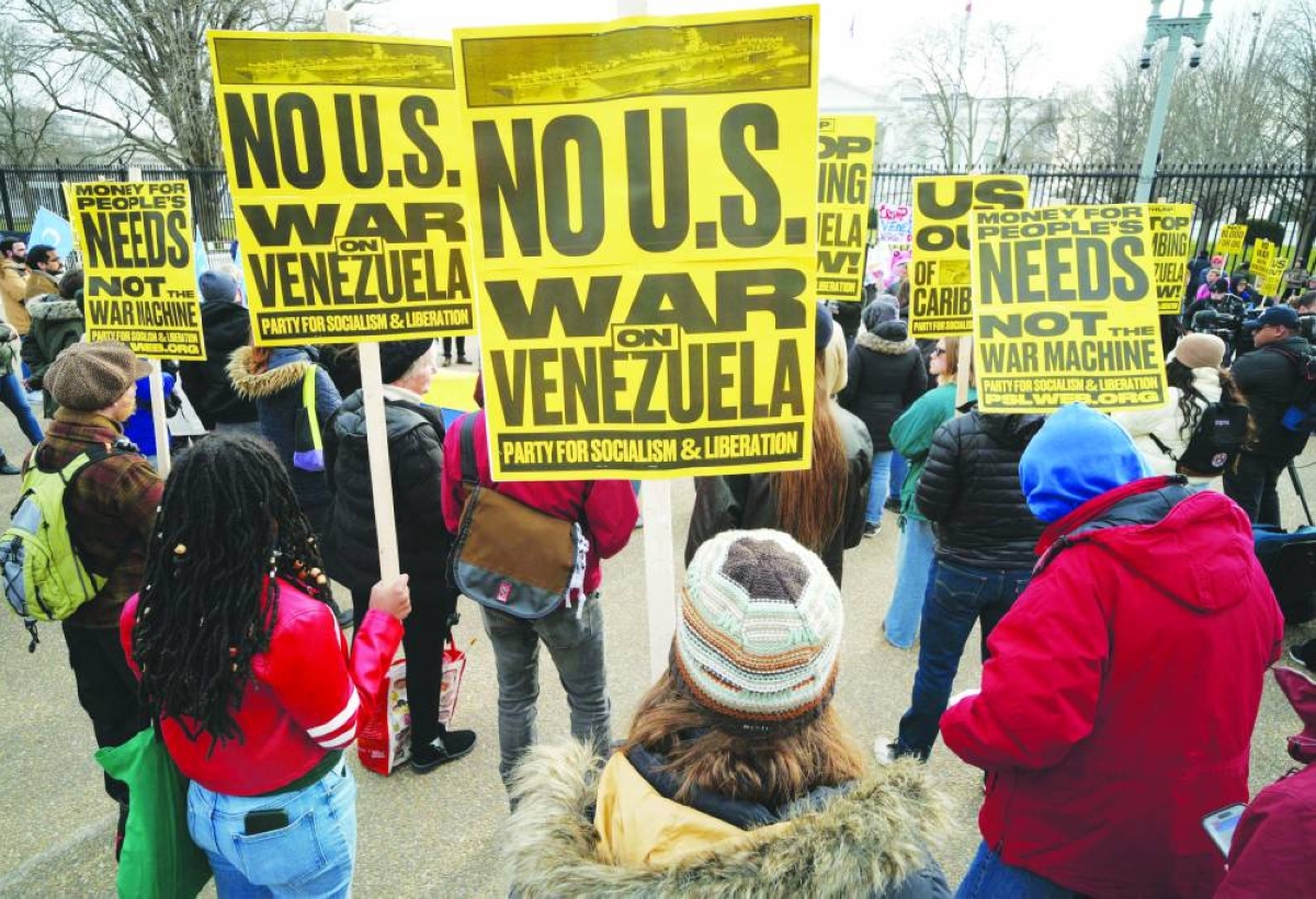 People take part in a demonstration in front of the White House in Washington, DC, against US military action in Venezuela. – AFP