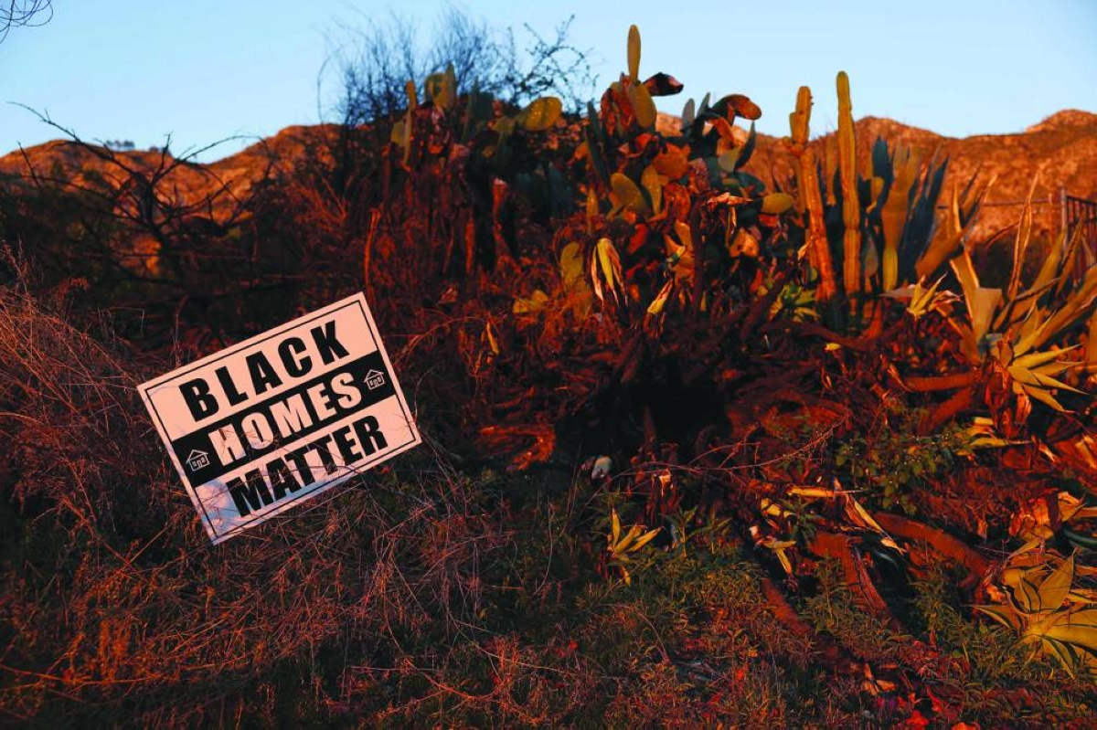 A ‘Black Homes Matter’ sign is displayed next to burned vegetation in front of the empty lot of a destroyed home on East Loma Alta Drive in Altadena, California. – AFP
