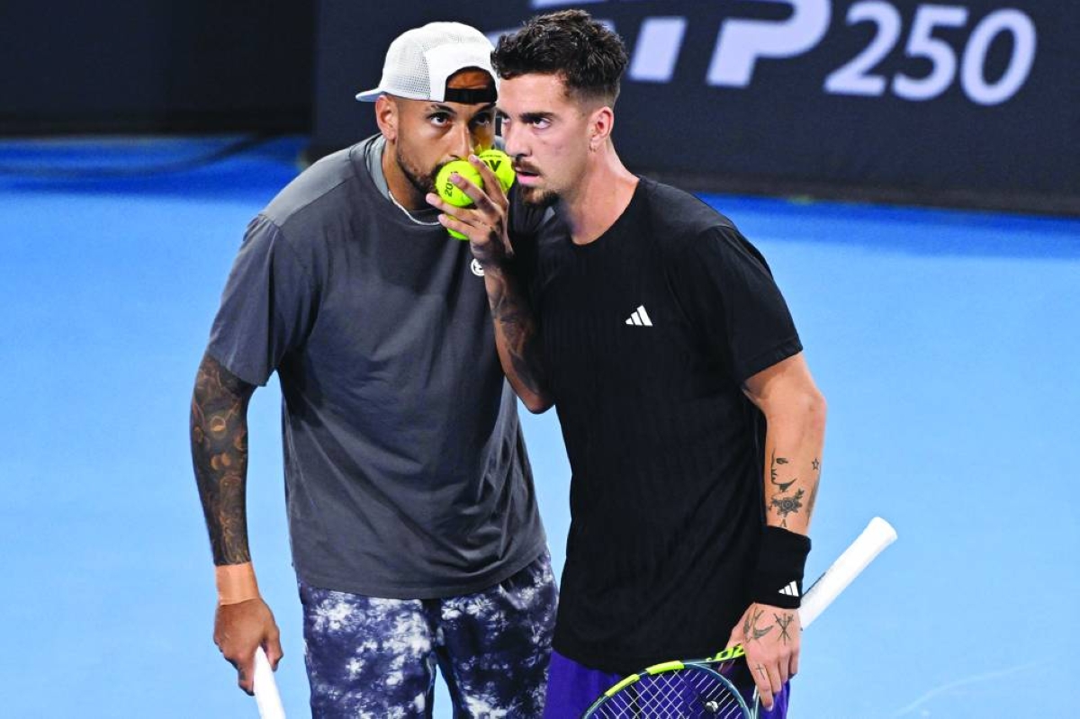 Nick Kyrgios (L) and Thanasi Kokkinakis (R) of Australia discuss tactics during their men's doubles match against Matthew Ebden of Australia and Rajeev Ram of the US at the Brisbane International tennis tournament in Brisbane on January 4, 2026. (Photo by William WEST / AFP) / --IMAGE RESTRICTED TO EDITORIAL USE - STRICTLY NO COMMERCIAL USE--