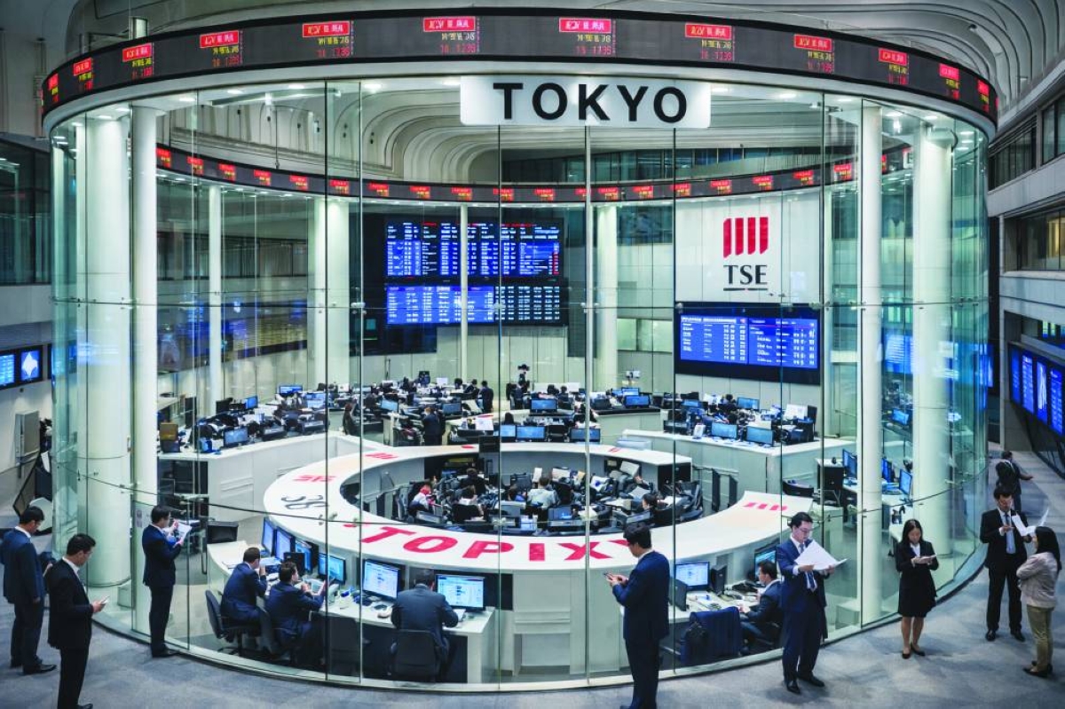 Traders work at the Tokyo Stock Exchange. The Nikkei 225 closed up 3.0% to 51,832.80 points Monday.
