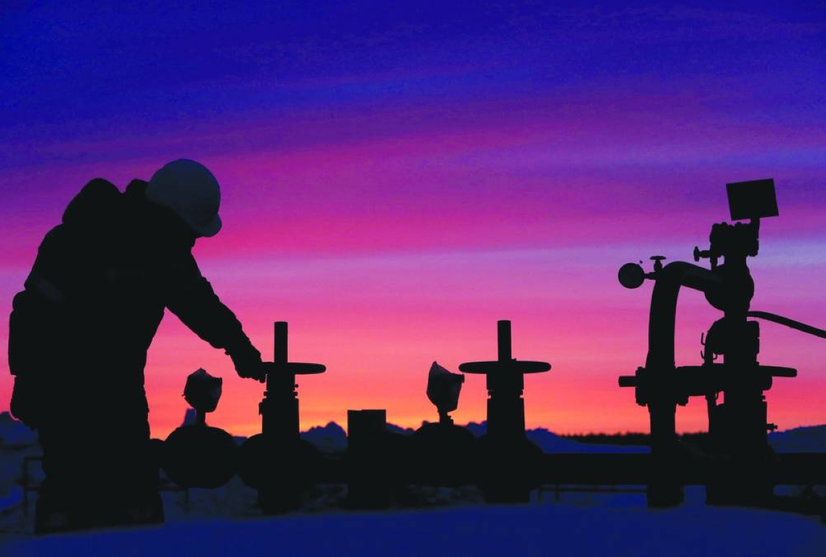 A worker checks the valve of an oil pipe at an oil field owned by Russian state-owned oil producer Bashneft near the village of Nikolo-Berezovka, northwest of Ufa, Bashkortostan, Russia. Brent and WTI prices declined by about 19% and 20% respectively in 2025, the most since 2020, weighed down by production boosts from OPEC , the US and other producers. 