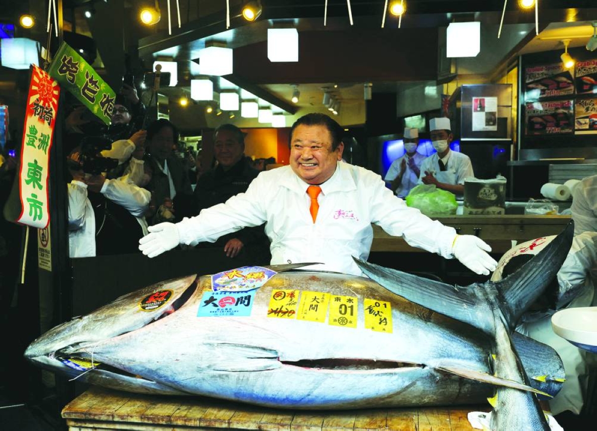 Kiyoshi Kimura poses with the 243kg bluefin tuna auctioned for a record 510mn yen ($3.24mn) at his sushi restaurant in Tokyo, Japan, Monday.
