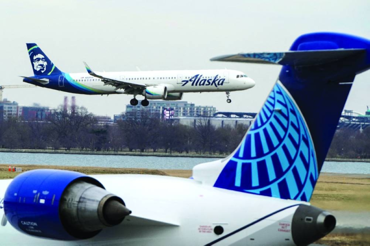 An Alaska Airlines aircraft flies past the tail of a United Airlines aircraft as it lands at Reagan National Airport in Arlington, Virginia. Alaska Airlines said ⁠Wednesday it will purchase 110 ⁠new Boeing aircraft - the largest single order in the carrier's history - as part of an aggressive expansion and fleet modernisation plan.