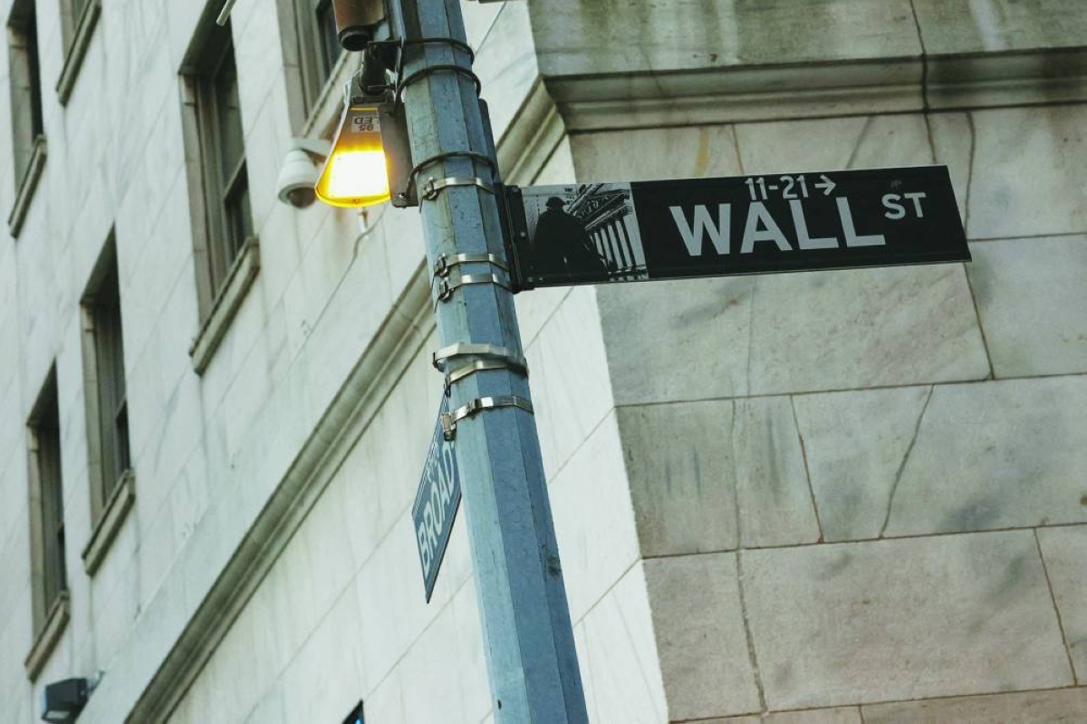 The Wall street sign hangs outside the New York Stock Exchange building. US stocks have kicked off 2026 on a strong note, but could face turbulence in ‌the coming days with the start of corporate earnings season, fresh inflation data and rising geopolitical ‌uncertainty.