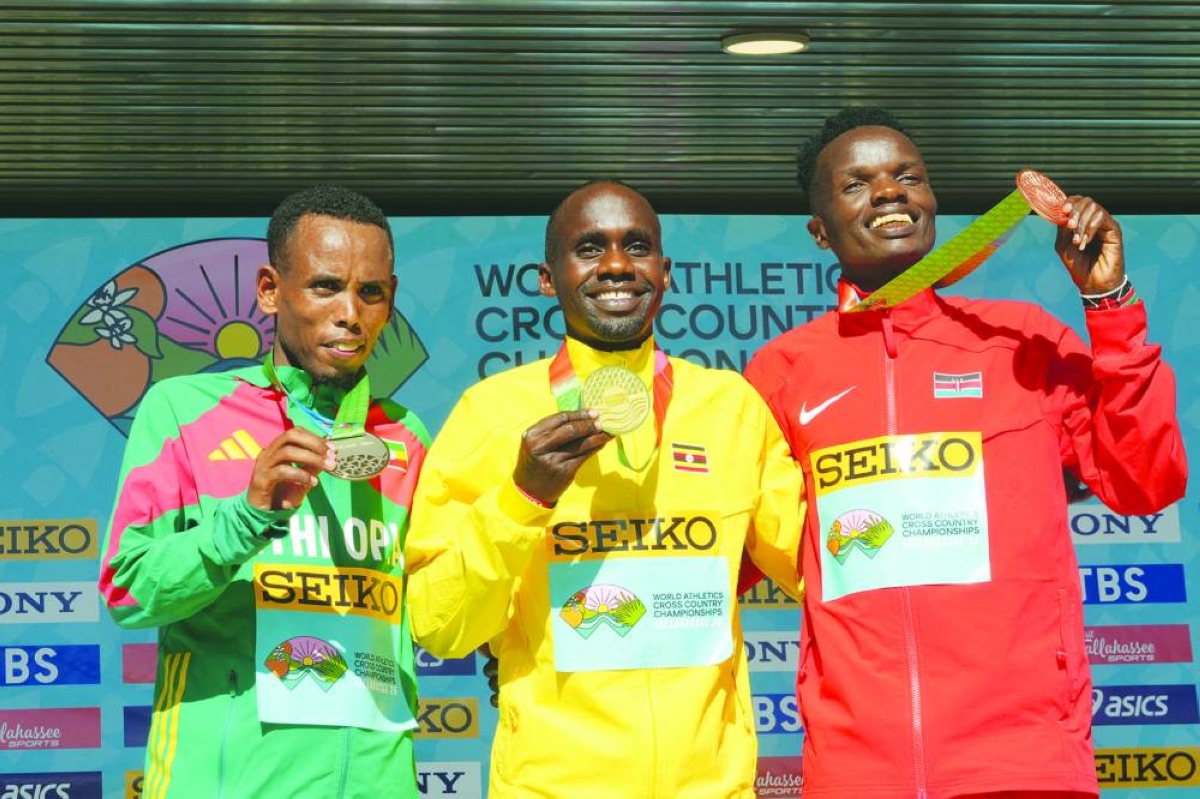 Jan 10, 2026; Tallahassee, FL, USA; Men's senior gold medalist Jacob Kiplimo (UGA), center, poses with silver medalist Berihu Aregawi (ETH), left, and bronze medalist Daniel Ebenyo (KEN) during the World Athletics Cross Country Championships Tallahassee 26 at Apalachee Regional Park. 