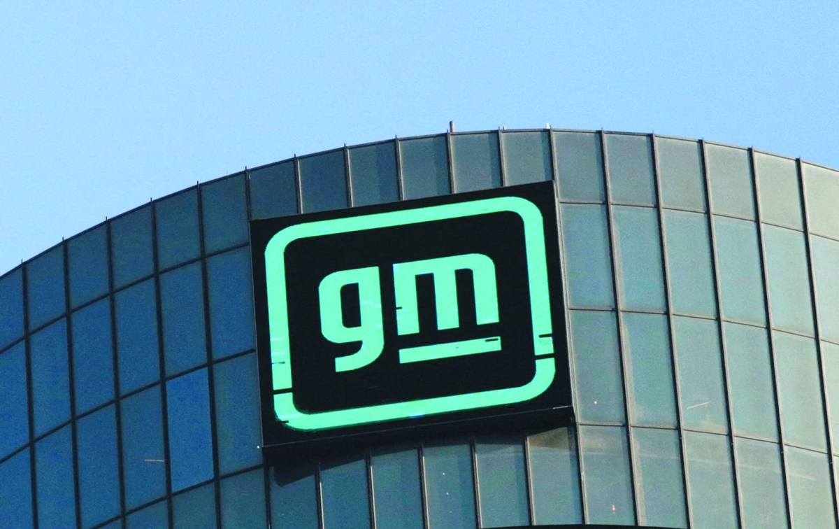 The GM logo is seen on the facade of the General Motors headquarters in Detroit, Michigan. The auto giant's fourth-quarter results will be dented by $6bn in charges connected to reversals on EV investments, according to a securities filing.