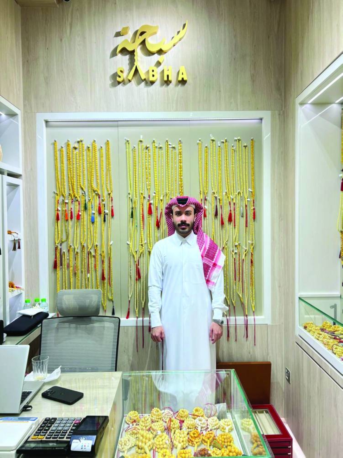Hassan Mahmoud al-Wadhan with displays of ambers rosaries
