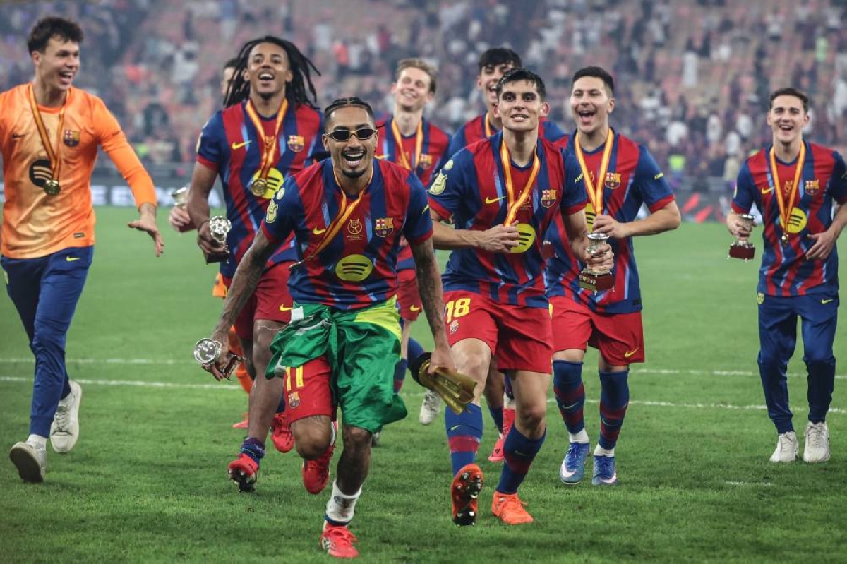 Barcelona's Raphinha celebrates with teammates after winning the Spanish Super Cup final against Real Madrid at the King Abdullah Stadium in Jeddah on Sunday. (AFP)