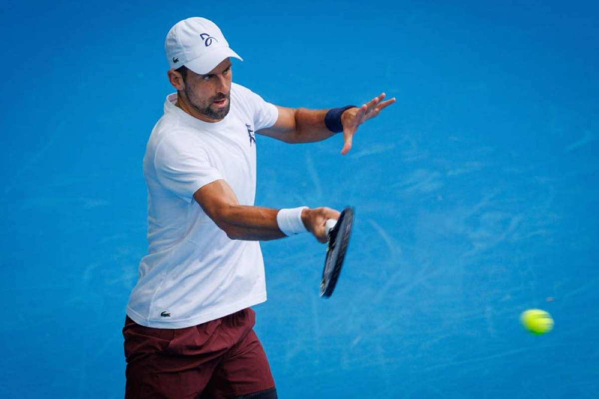 Serbia’s Novak Djokovic hits a forehand during a training session against Czech Republic Jiri Lehecka in preparation for the Australian Open in Melbourne. (AFP) 